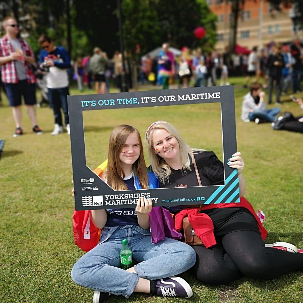 Members of the public pose in the selfie frame at Hull Pride