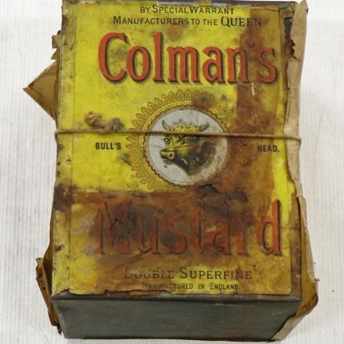 A Colman's mustard tin before treatment