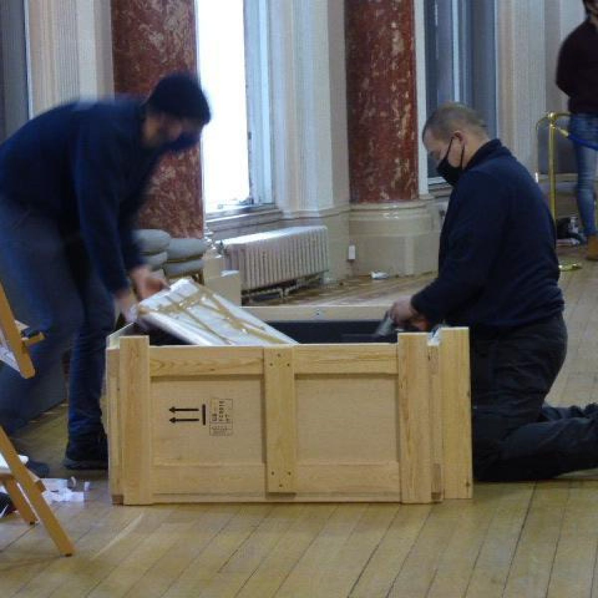 Paintings Are Carefully Placed In The Crates