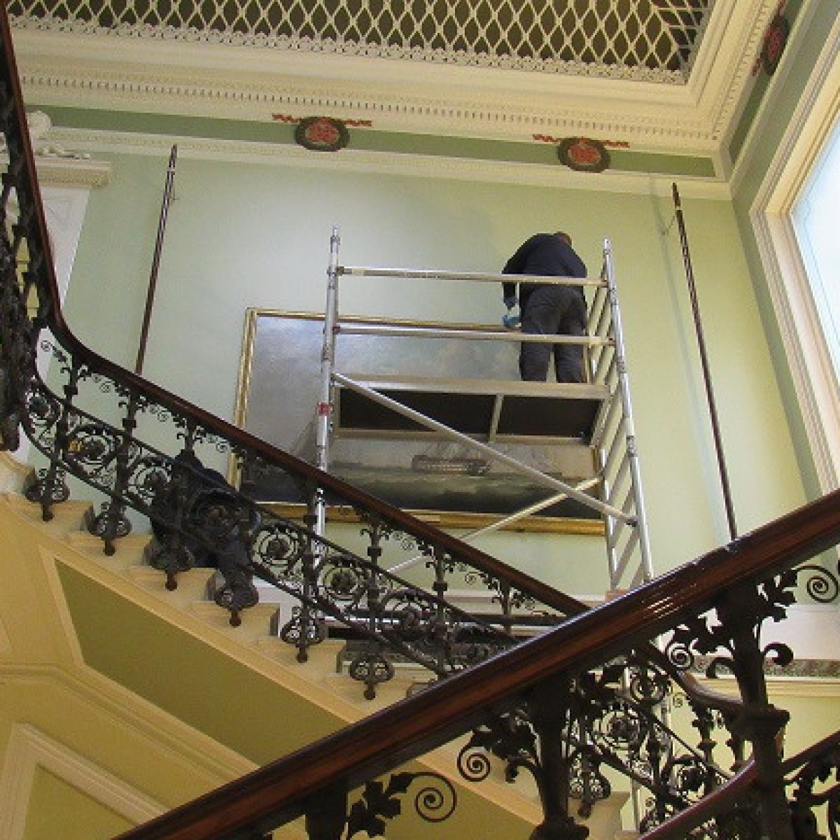 Technicians Start To Remove The Painting From The Stairwell Wall