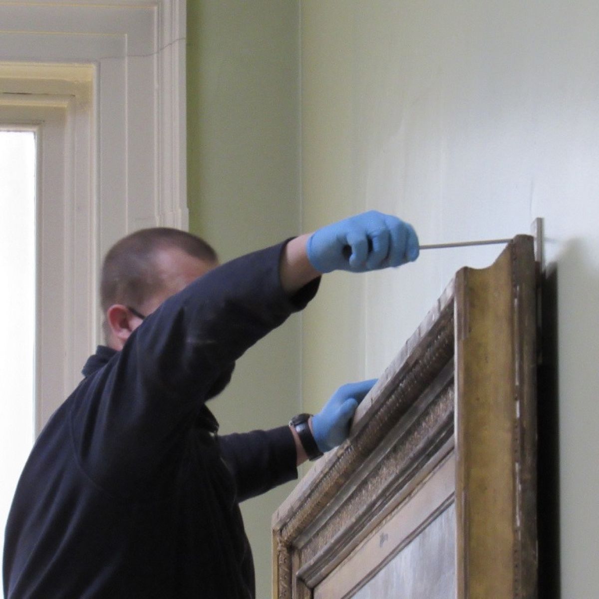 Technicians Start Work To Remove The Painting From The Wall