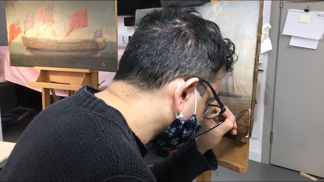 A conservator retouching Martin Samuelsons Shipyard